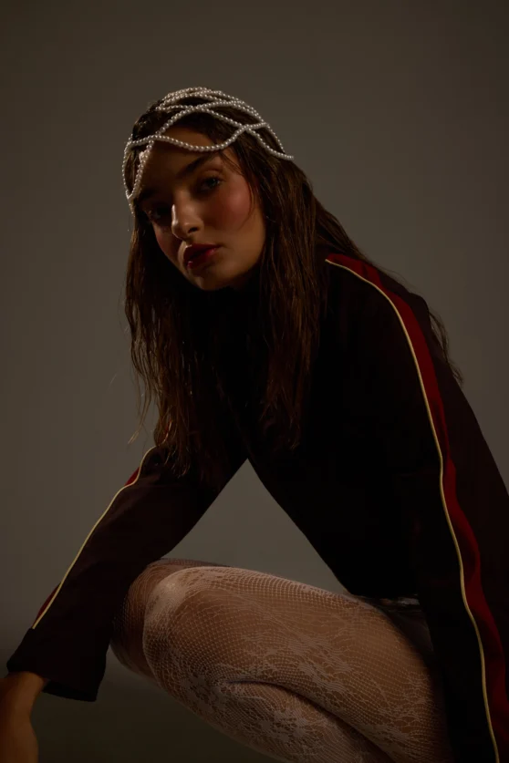 Studio pose of model in sporty top and metallic skirt for e-commerce portfolio